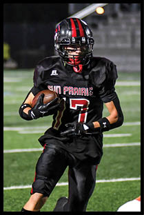 A football player running on the field. Description generated by AI