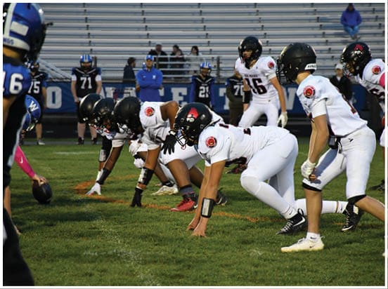 A football player wearing a blue jersey with the number 58 on it. Description generated by AI