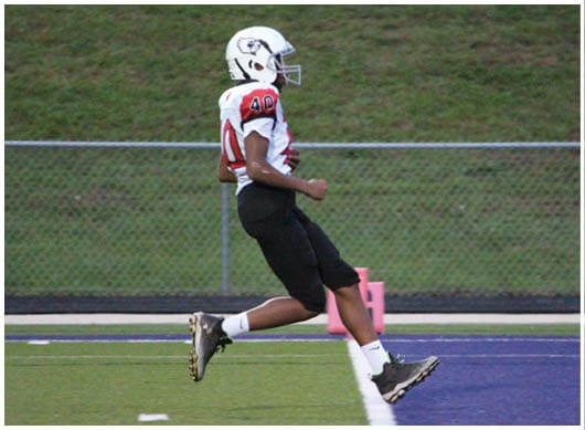 A football player catching a ball. Description generated by AI