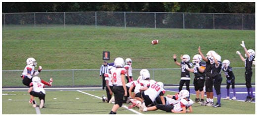 A football player catching a ball. Description generated by AI