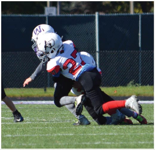 A football player catching a ball. Description generated by AI