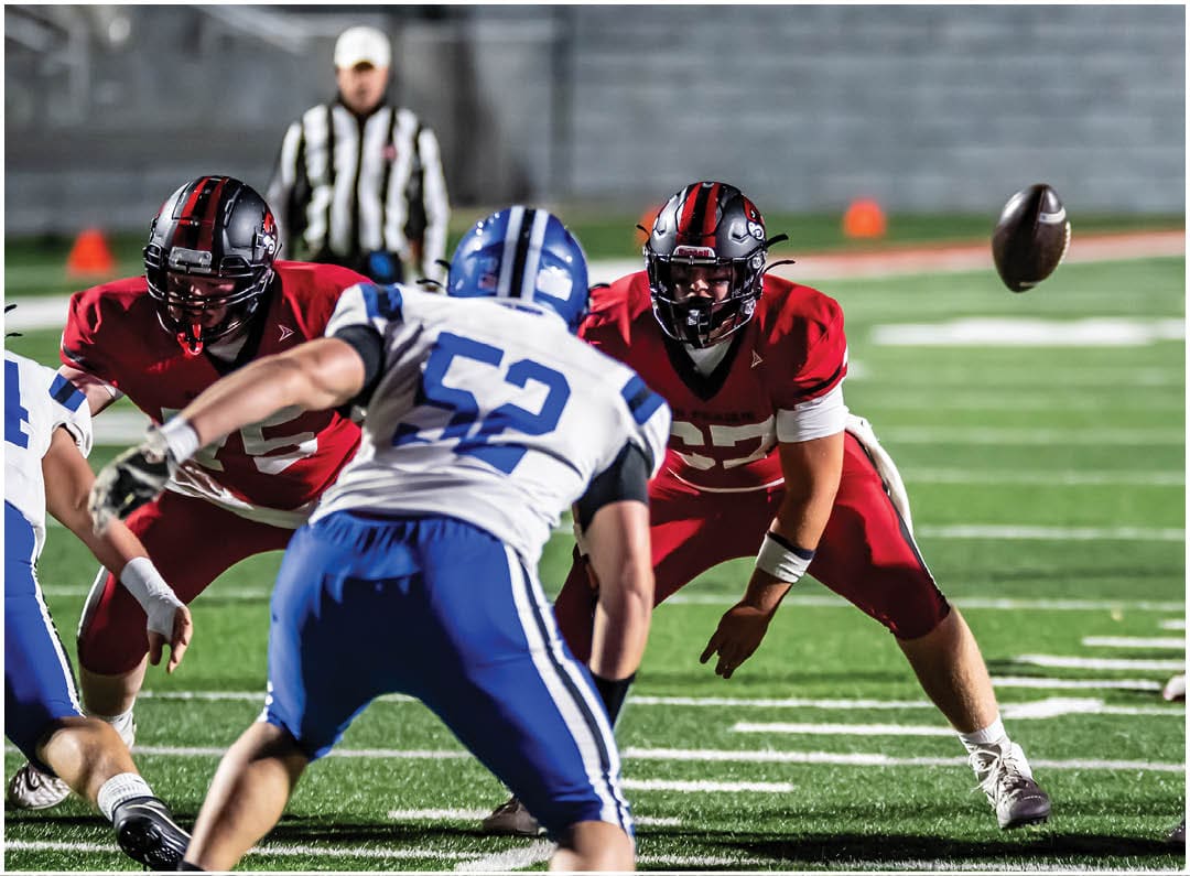 A football player wearing a blue jersey with the number 58 on it. Description generated by AI