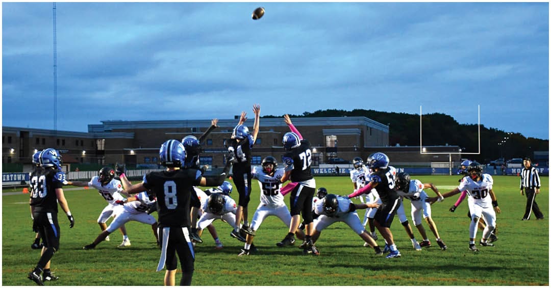 A football player wearing a blue jersey with the number 58 on it. Description generated by AI