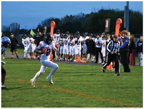 A football player wearing a blue jersey with the number 58 on it. Description generated by AI