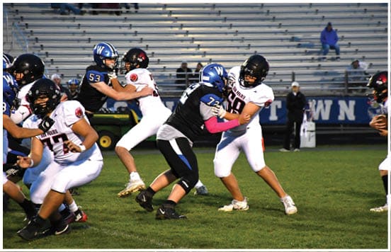 A football player wearing a blue jersey with the number 58 on it. Description generated by AI