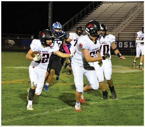 A football player wearing a blue jersey with the number 58 on it. Description generated by AI