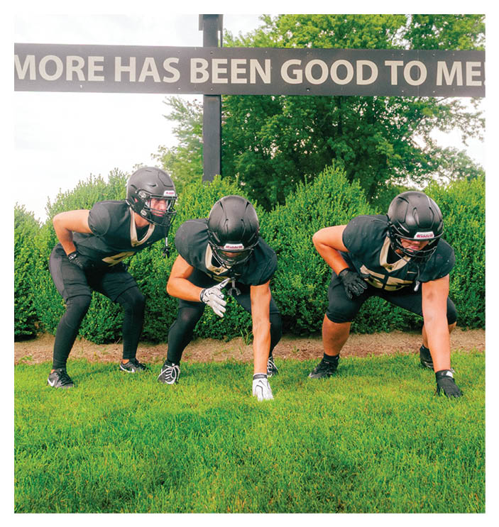 A group of football players walking on the field. AI generated content