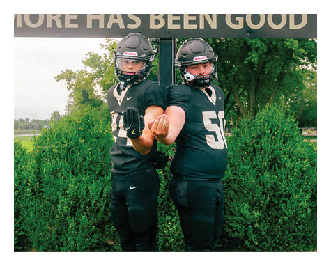 A man wearing a football uniform is jumping to catch a football. AI generated content