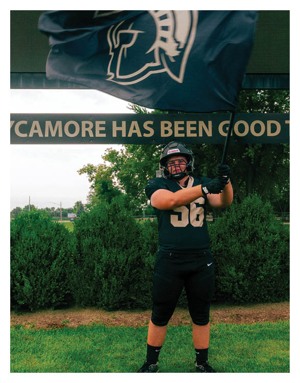 A football player wearing a helmet and white uniform is holding his helmet above his head. AI generated content