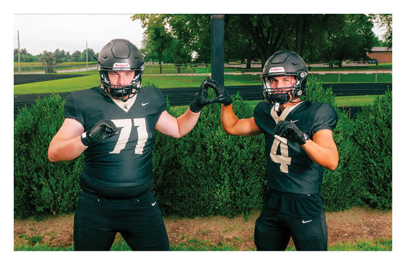 A group of football players wearing headphones and smiling. AI generated content