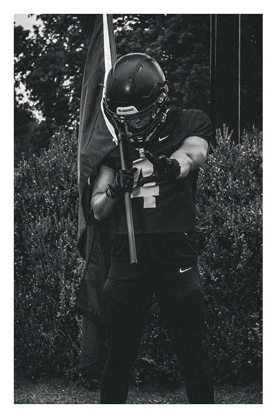 A young man wearing a football jersey with the name Vista on the back. AI generated content