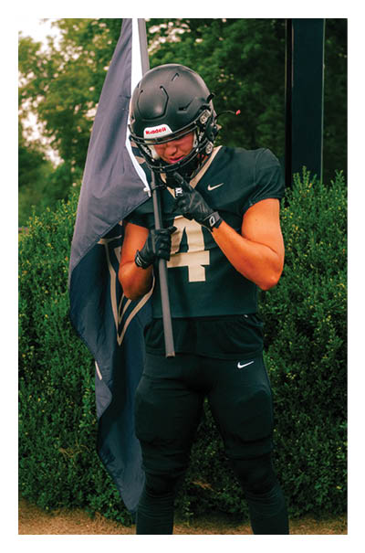 A football player wearing a black and white uniform with the number 10 on the back. AI generated content