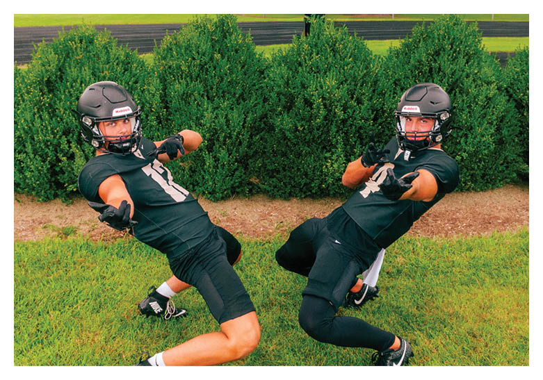 A group of football players on a field, one of them is running with a football. AI generated content