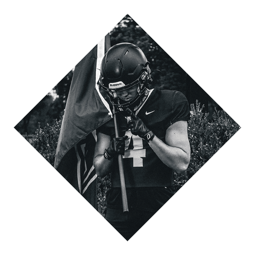 A female football player is kicking a football on a field. AI generated content