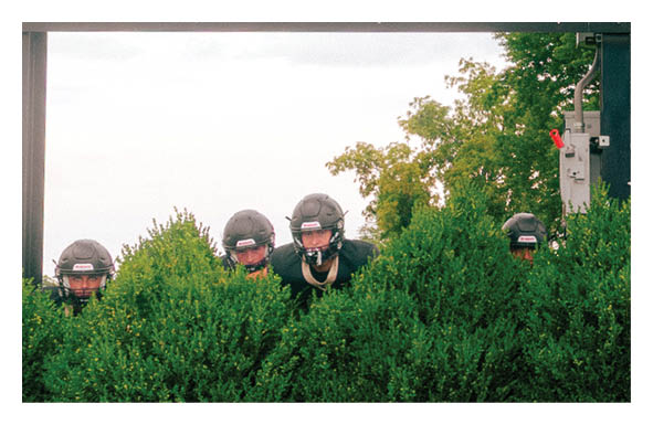 A group of people are kneeling on a field, possibly in a football game. AI generated content
