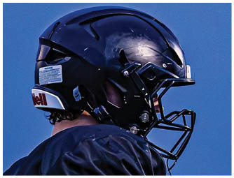 A group of football players on a field. Description generated by AI