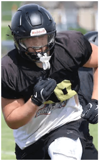 A football player catching a ball. Description generated by AI