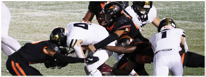 A football player is sliding on the ground. Description generated by AI