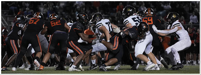 A football player is sliding on the ground. Description generated by AI