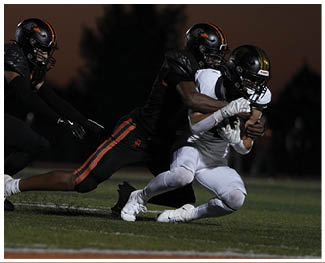 A football player running on the field. Description generated by AI