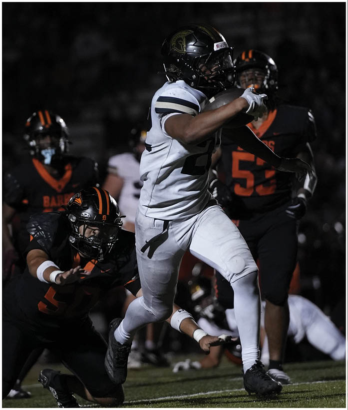 A group of football players wearing black and white uniforms. Description generated by AI