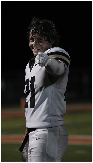 A football player running on the field. Description generated by AI
