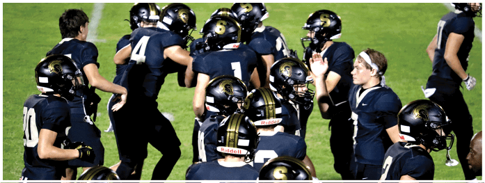 A football player is sliding on the ground. Description generated by AI