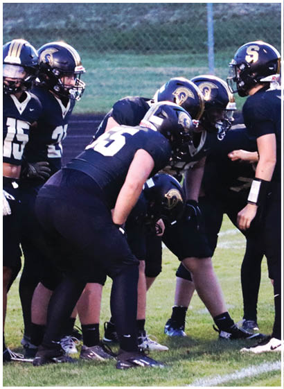 A football player wearing a blue jersey with the number 58 on it. Description generated by AI