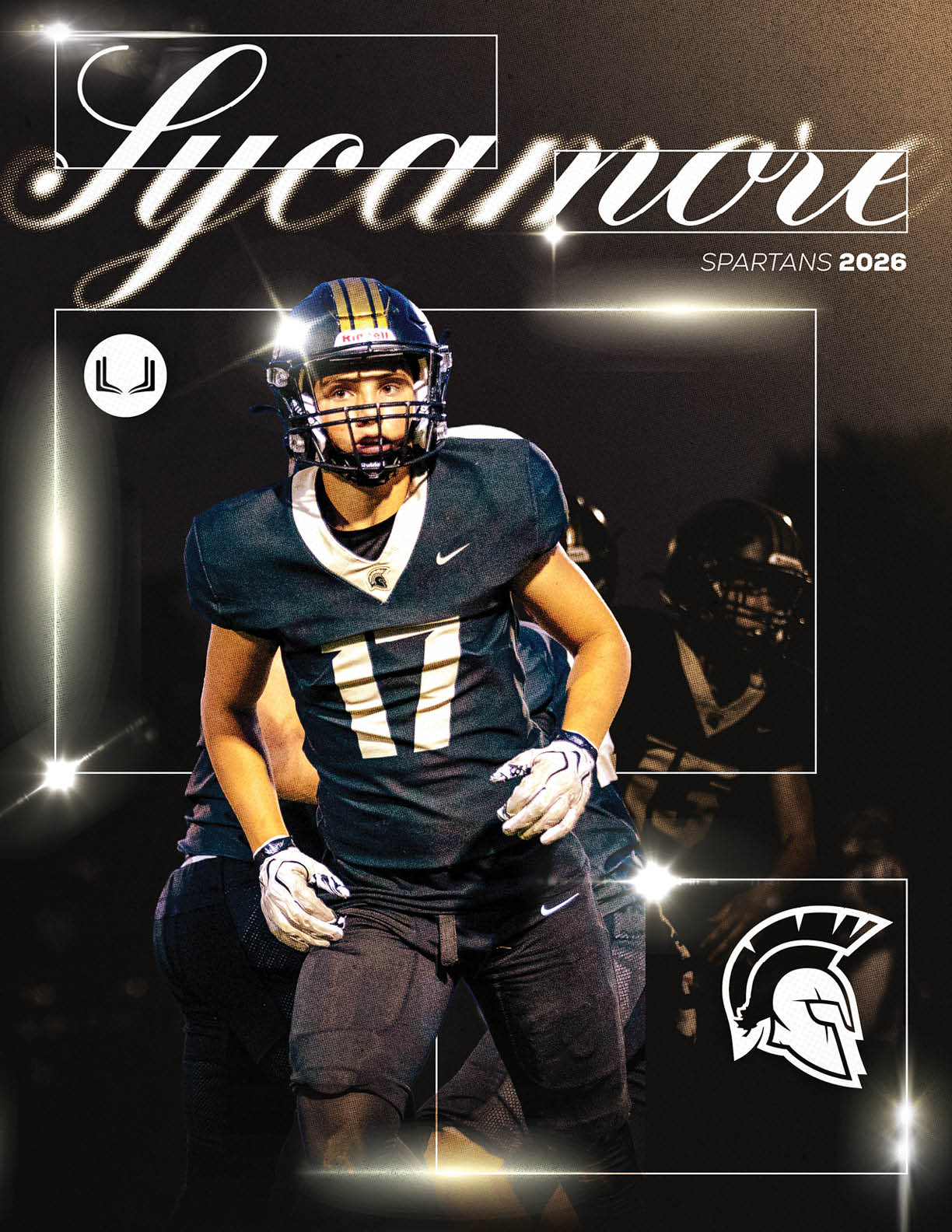 An adult wearing a dark football uniform with the number 17 and a helmet is standing on a field with a blurred background of other players, with stylized text reading Sycamore Spartans 2026 and a Spartan helmet logo. Description generated by AI
