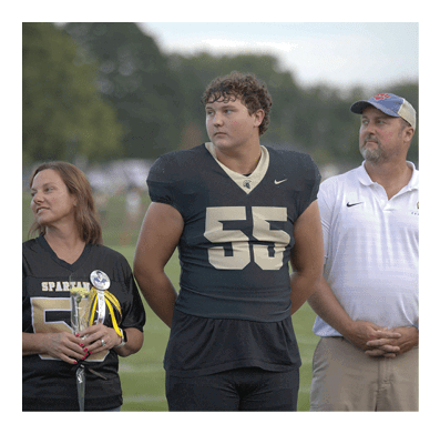 A football player in a white jersey with the number 85 on it is trying to catch a football. AI generated content