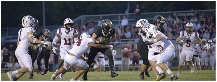 A football player is sliding on the ground. Description generated by AI