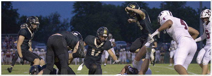 A group of football players on a field. Description generated by AI