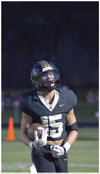 A football player running on the field. Description generated by AI