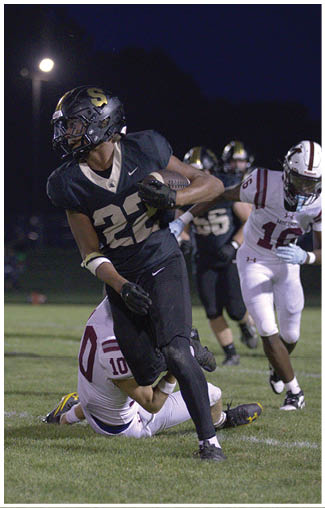 A football player running on the field. Description generated by AI