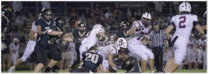 A group of football players on a field. Description generated by AI