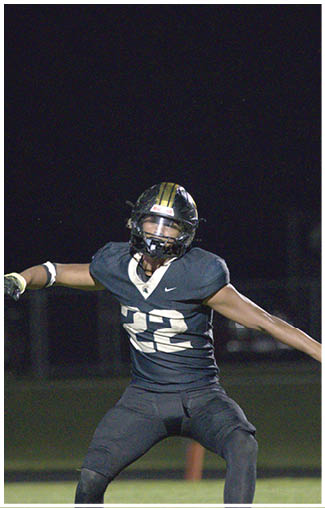 A football player running on the field. Description generated by AI