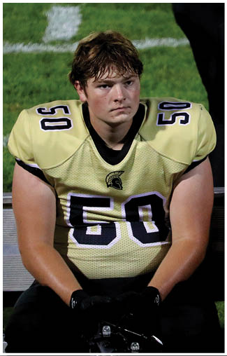 A person wearing a yellow sports jersey with the number 50 on the shoulder and part of another number visible on the chest. Description generated by AI