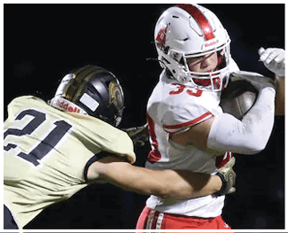 A person wearing a light-colored sports jersey with the number 22 is captured in motion against a dark background. Description generated by AI