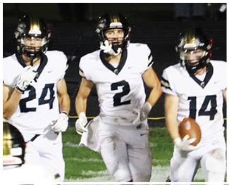 Three people in white football uniforms with black helmets are running on a field, with one holding a football. Description generated by AI