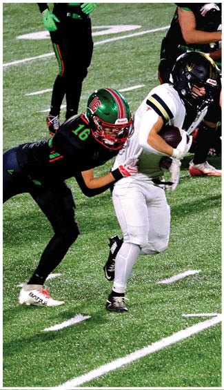 A person wearing white football gear is running on a green field while holding a football securely. Description generated by AI