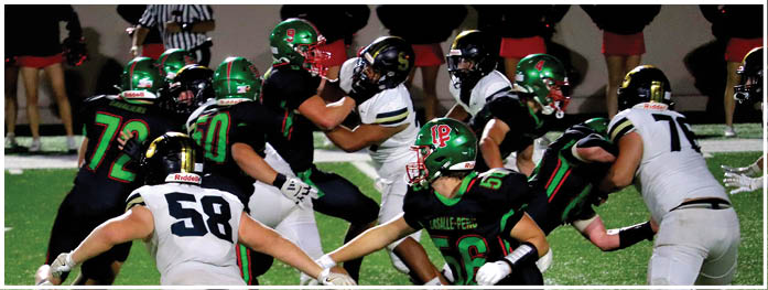 People in football uniforms are actively engaged in a play on a grassy field during a game. Description generated by AI