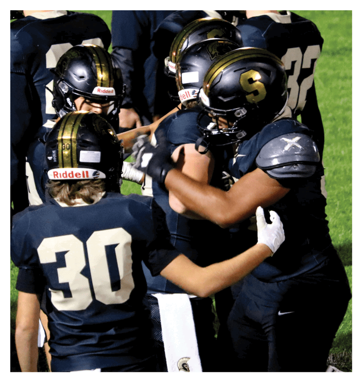 A group of football players walking on the field. AI generated content