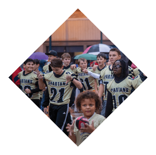 A football player wearing a black jersey with the number 16 on it is holding a football. AI generated content
