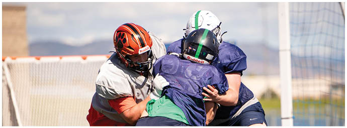 A football player wearing a blue and white uniform. Description generated by AI