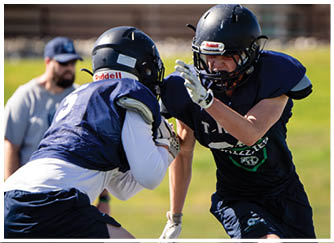 A football player catching a ball. Description generated by AI