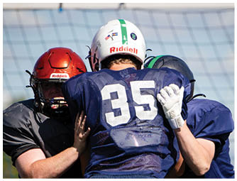 A group of football players on a field. Description generated by AI