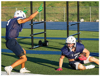 A group of football players on a field. Description generated by AI