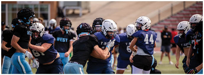 A football player wearing a blue and white uniform. Description generated by AI