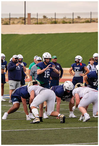 A football game is being played on a field. Description generated by AI