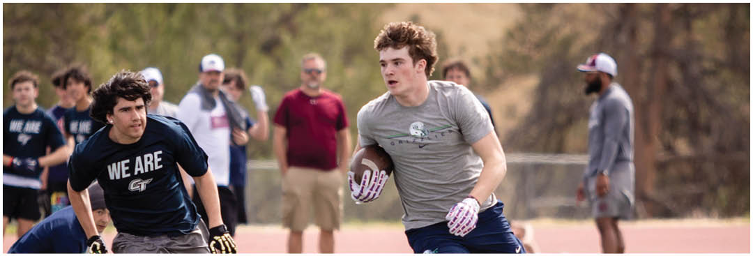 A football player wearing a blue and white uniform. Description generated by AI